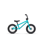 The Wethepeople Prime Balance BMX Bike for children is displayed on a white background, showcasing its teal frame with black wheels, a black seat, and sturdy handlebars.