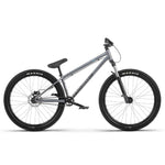 The Radio 26 Inch Asura Pro Bike in silver features black handlebars, Maxxis-branded black tires, and a rear suspension system. Its durable dirt jump frame is equipped with hydraulic disc brakes. The bike is displayed against a plain white background.