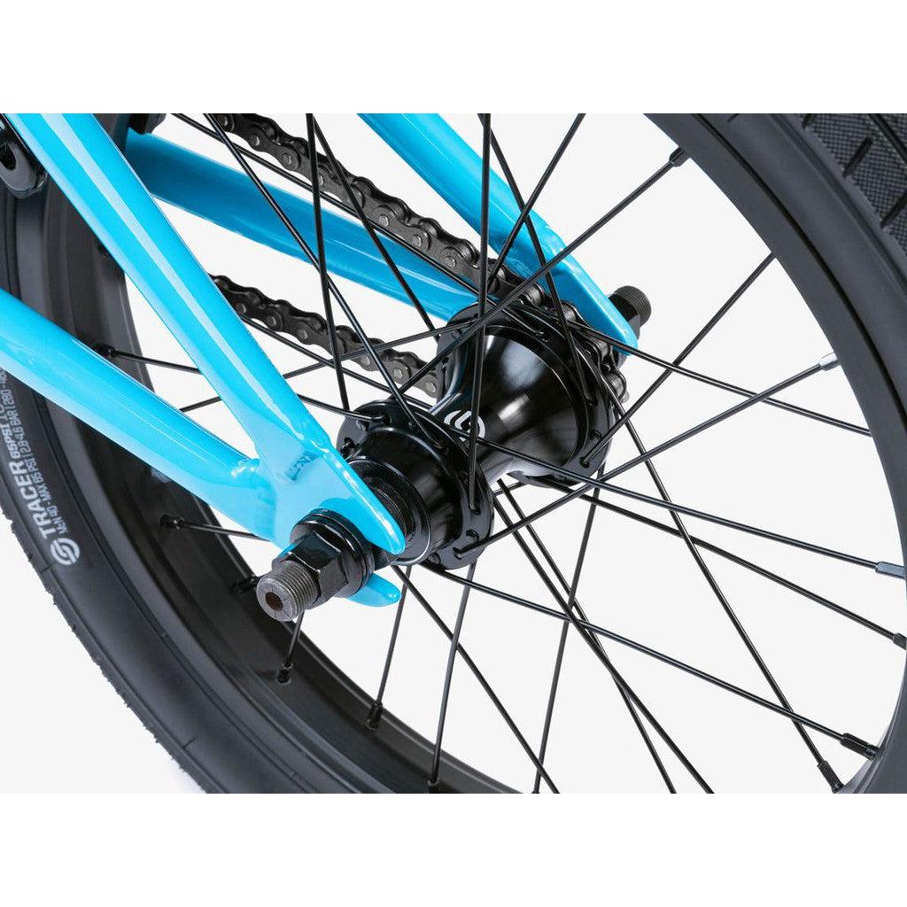 Close-up of the Wethepeople Seed 16 Inch Bike's BMX shredder rear wheel, showcasing the hub, spokes, and chain on a turquoise frame with black tires. Perfect for young riders aiming to master this experience.