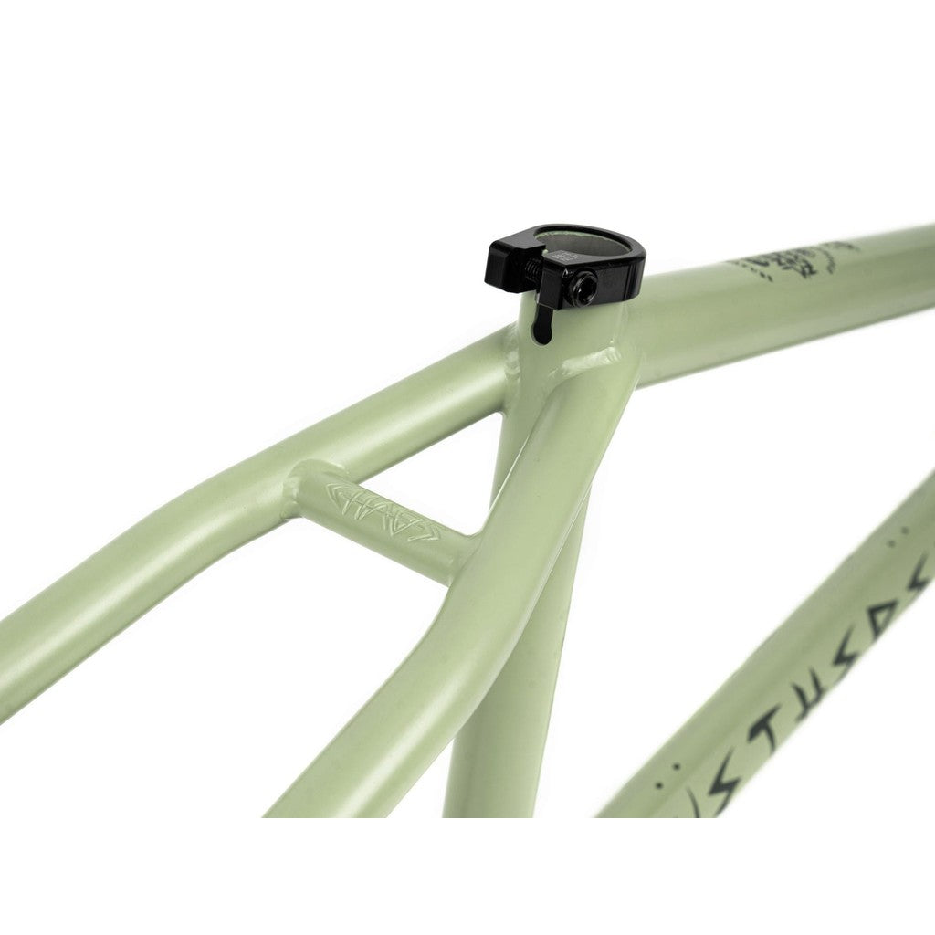 Close-up of the 22-inch Wethepeople Chaos Machine Frame (Tyson Jones-Peni Signature) in light green, featuring a black seat clamp, disc brake mount, angular lines, and minimal decals—ideal for riders seeking trail geometry.