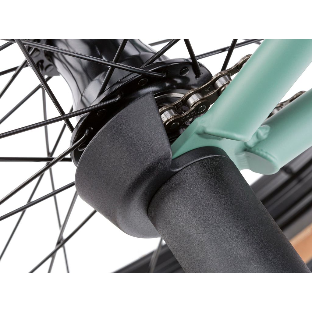 Close-up of a bicycle's rear wheel hub and chain, showcasing detailed gear mechanisms and black and teal frame components, enhanced with the Cinema VR Universal Rear Hub Guard for optimal rear hub protection.