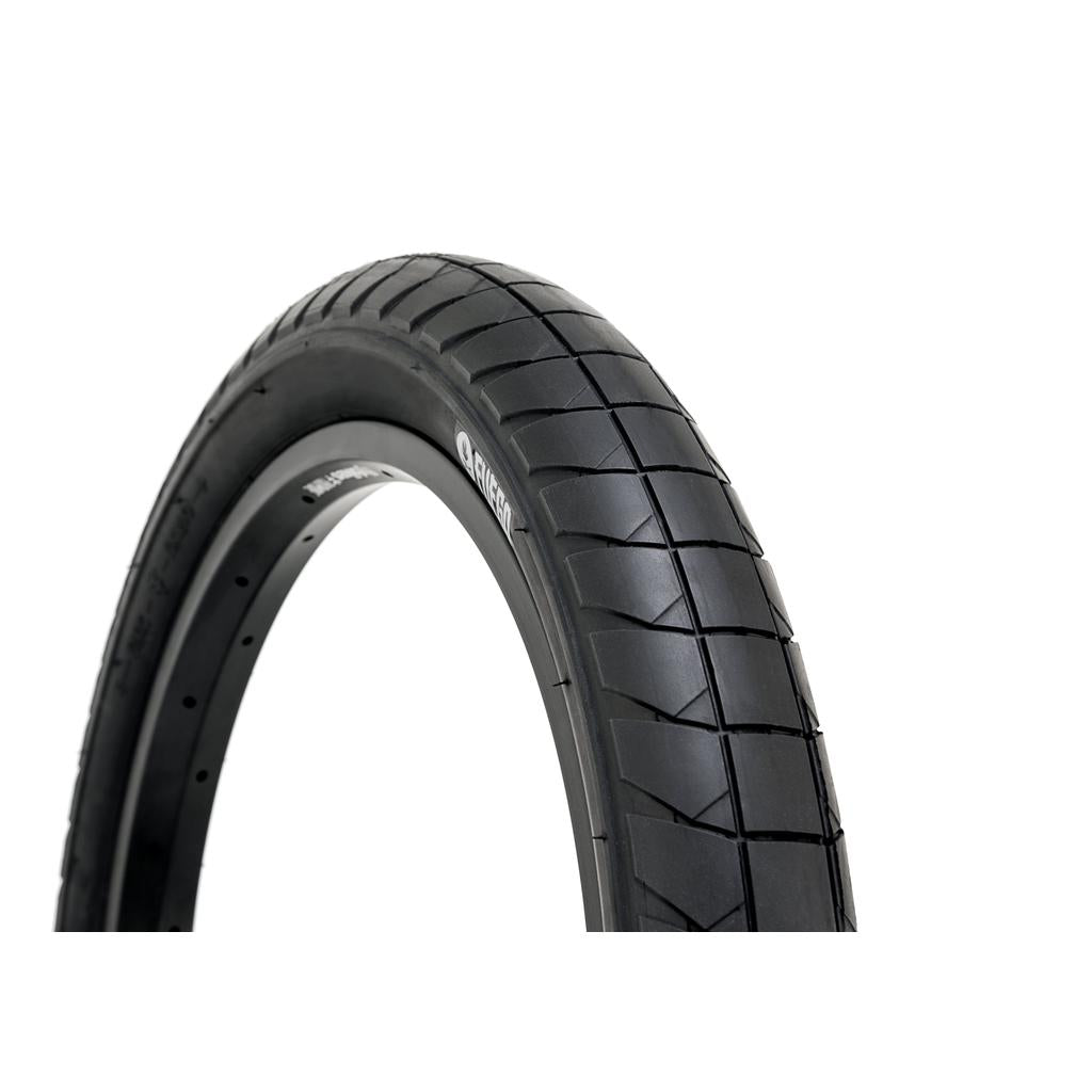 Close-up of the Fly Bikes Fuego Tyre in black, featuring a tread pattern for puncture resistance, displayed against a white background.