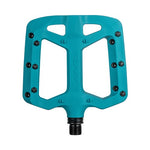 The Funn Taipan Pedals feature a teal flat design with multiple pins for traction and a black threaded spindle, ensuring durability.