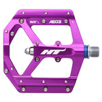 The HT AE03 Pedals are designed from CNC aluminum with sleek purple pedals featuring silver grip studs. They are labeled "Evo L AE03" and have durable, replaceable SAP pins for a reliable cycling experience.