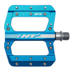 The HT AE12 Pedals are blue flat bicycle pedals marked "L," made from CNC aluminum, featuring a silver axle and multiple metal pins for optimal grip.