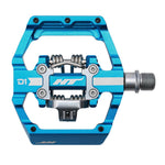 The HT D1 Dual Function Clip/Flat Pedals feature a blue aluminum body with a metal spindle, spring mechanism, sealed bearings for longevity, and "D1" and "HT" labels for a smooth performance.