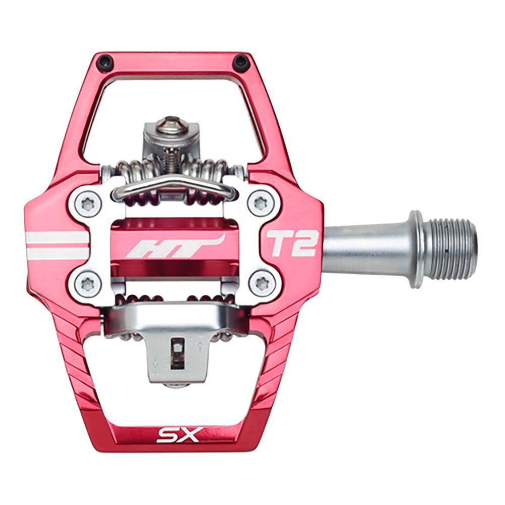 The HT T2-SX Clip In Pedals are red and silver, feature a durable chromoly spindle, have "HT" and "T2" markings, and include a clipless cleat system.