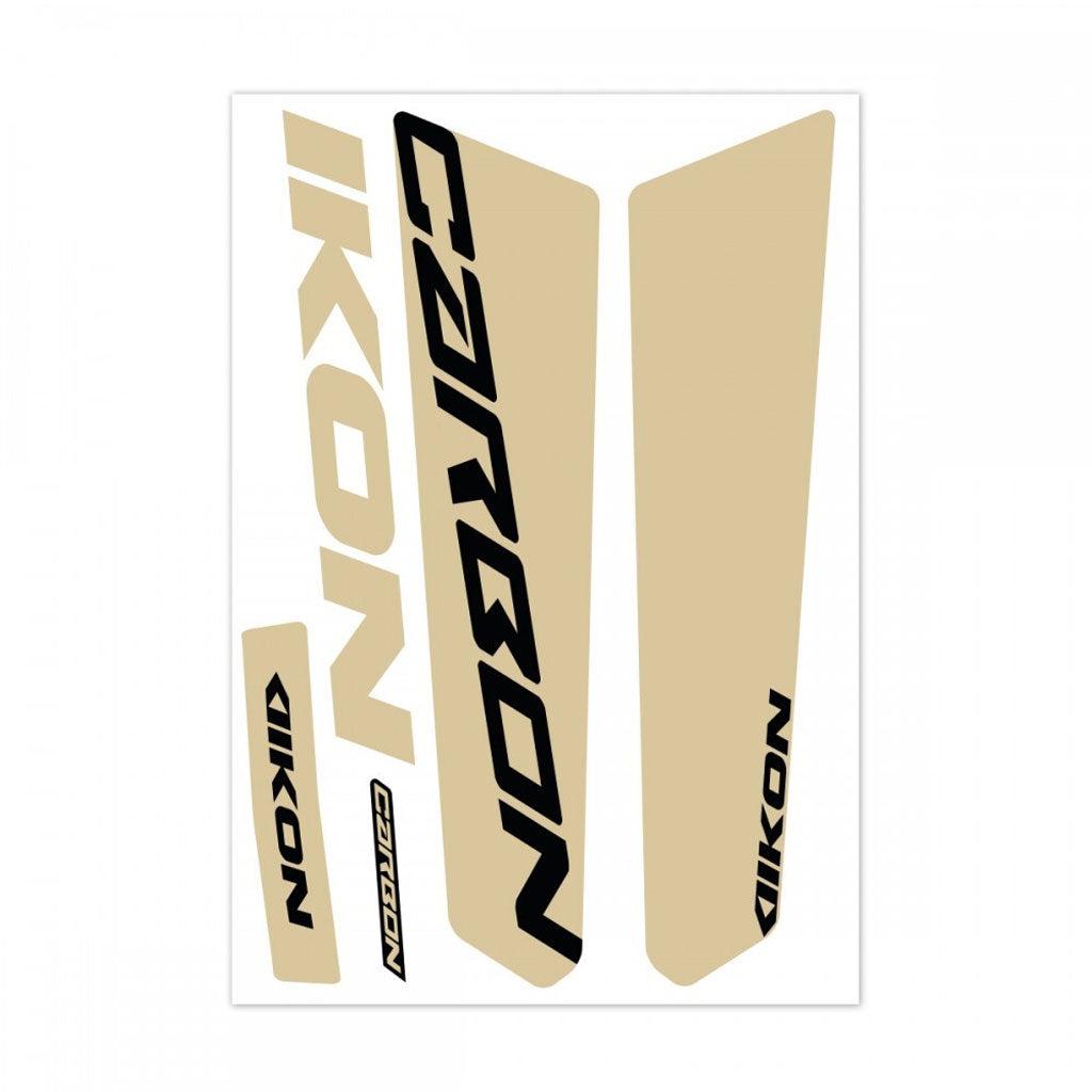 Decals from the "IKON Fork Leg Sticker Kit 20" PRO-Tapered," featuring the words "CARBON" and "IKON" in bold black letters on a beige background reminiscent of Ikon race decals, are arranged in various sizes and angles to perfectly complement Chase ACT frames.