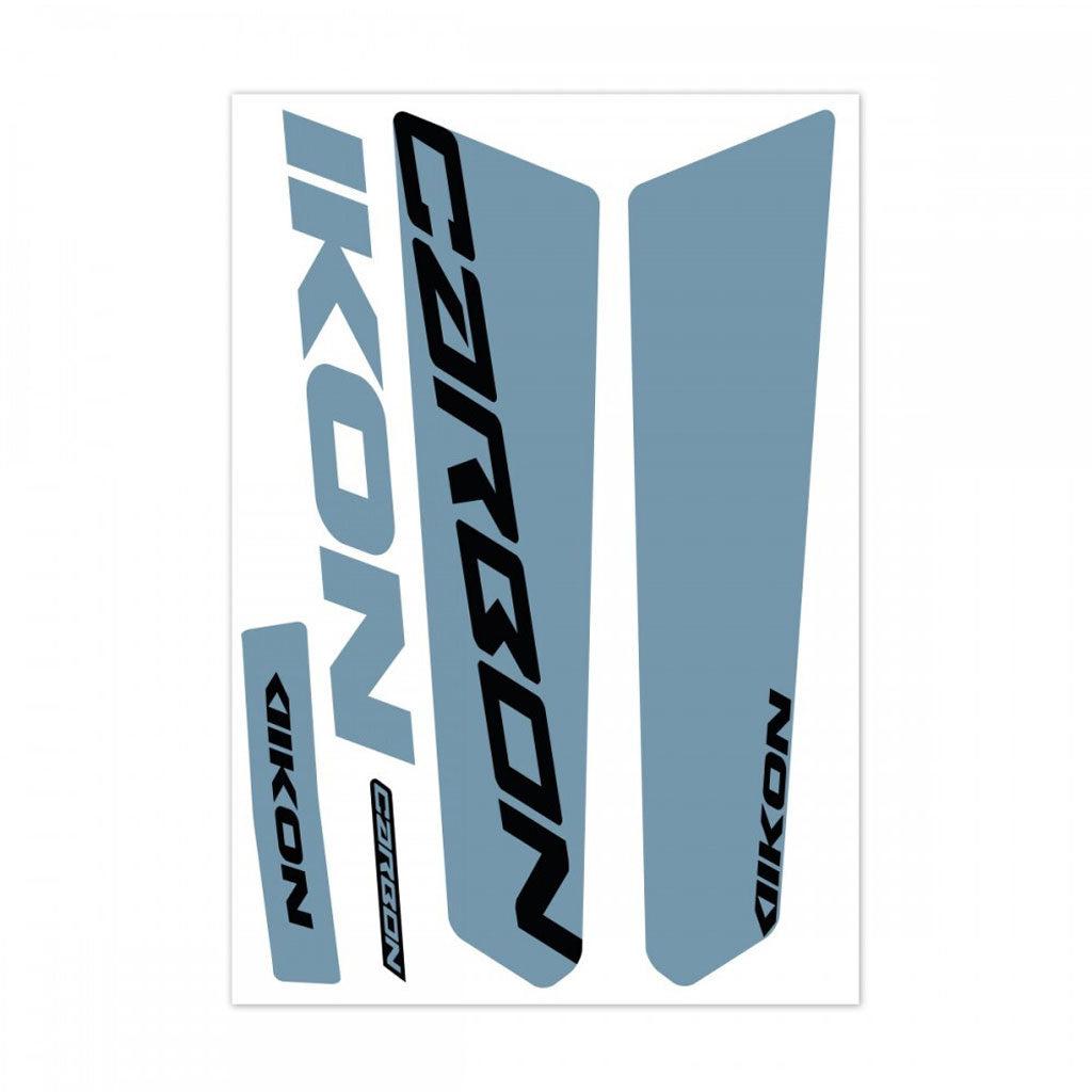 The IKON Fork Leg Sticker Kit 20" PRO-Tapered features a set of race decals with the word "CARBON" in bold black letters and "IKON" in blue text on a white background, ideal for stylishly enhancing Chase ACT frames.