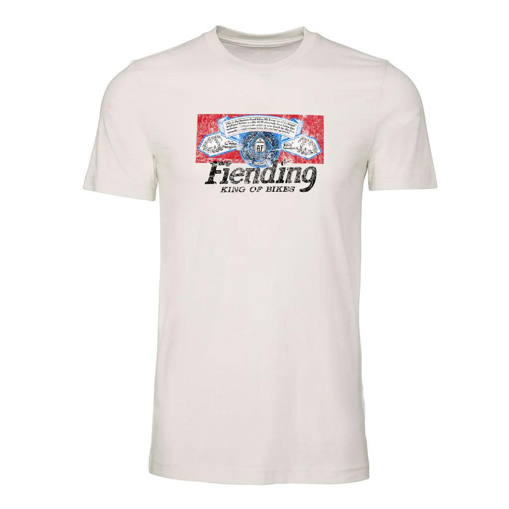 A Fiend Shirt King of Bikes (Vintage White) unisex T-shirt featuring an illustration of a person with sunglasses and a helmet set against a red and blue background, with the text "Bending King of Bikes" printed below.