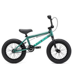 A small teal Kink Pump 14 Inch Bike (2025) with thick black tires, a black seat, and black handlebars, ideal for young riders.