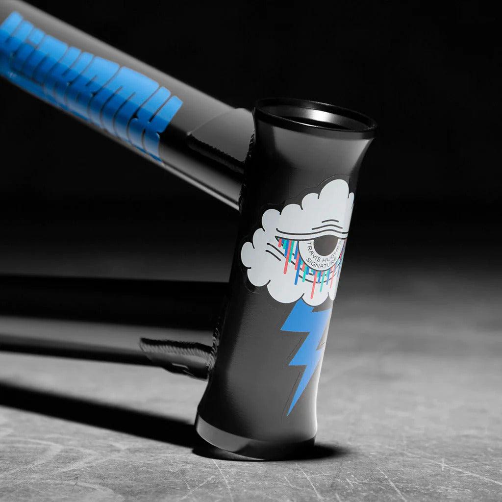 A close-up of the Travis Hughes Kink Cloud Frame's head tube shows a black finish with an eye-in-cloud graphic and blue lightning bolt, crafted from durable chromoly tubing for ideal street riding.