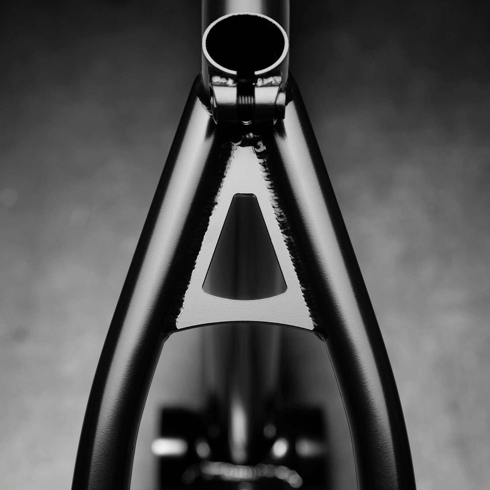 A close-up of the black Kink Roll Up Frame showcases a triangular opening, emphasizing the street geometry of the seat tube and rear stays.