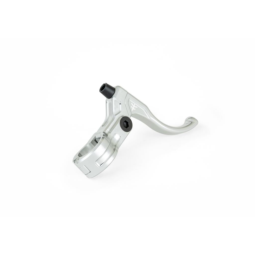 The Fly Bikes Manual CNC Brake Lever, in silver, is made from durable 6061-T6 Aluminum with an engraved logo. It features a black bolt and ergonomic curve, enhanced by an Igus polymer bushing for smooth operation, all isolated on a white background.