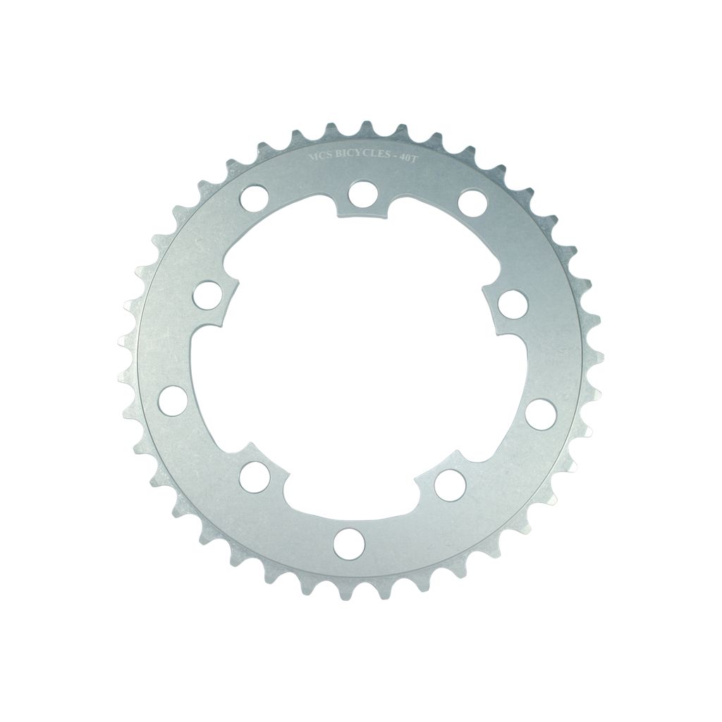 A silver MCS 110BCD 5 Bolt Chainring with "Vics Bicycles" and "40T" engraved on the top, featuring 40 teeth and multiple bolt holes for attachment, crafted from 6061 aluminium.