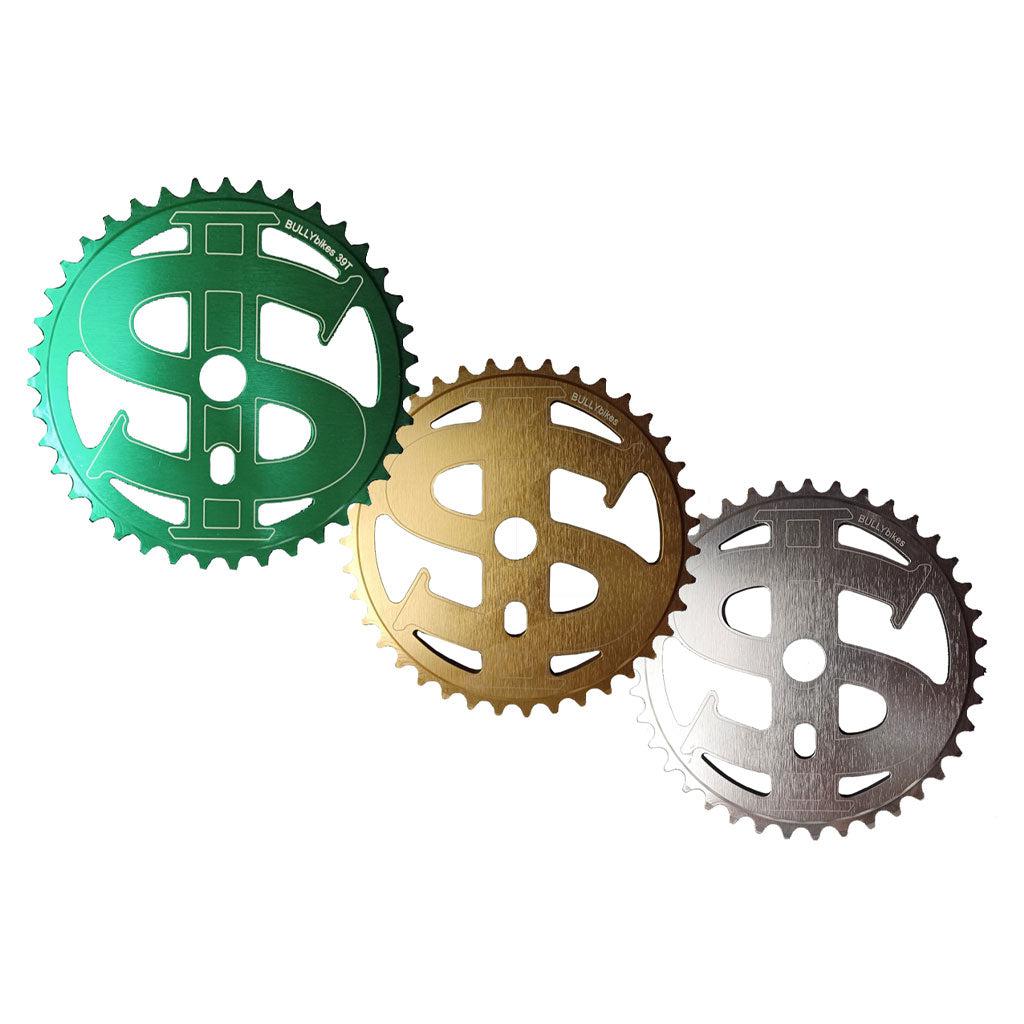 The MCS Bully Big Money Chainwheel comes in green, gold, and silver, each shaped like a dollar sign and crafted from 6061 aluminum alloy by Bully Bikes BMX.