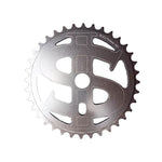 The MCS Bully Big Money Chainwheel is a metallic chainwheel made from 6061 aluminum alloy, featuring a distinctive dollar sign cutout design, perfect for BMX enthusiasts riding Bully Bikes.