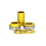 The Fiend Mid Bottom Bracket, consisting of yellow and silver mechanical components, includes cylindrical and ring-shaped parts with machined alloy cones for enhanced durability.