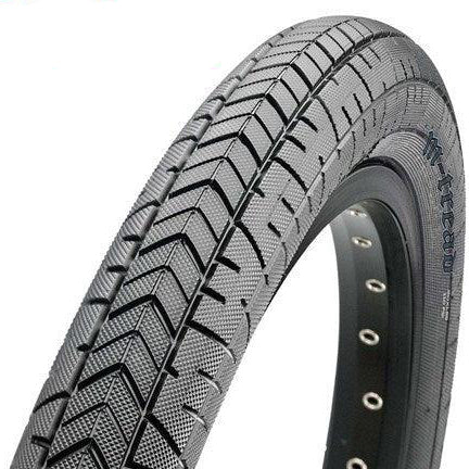 A close-up of the Maxxis M-Tread Tyre showcases its unique tread pattern and visible metal eyelets along the rim, boosting tire life and performance.