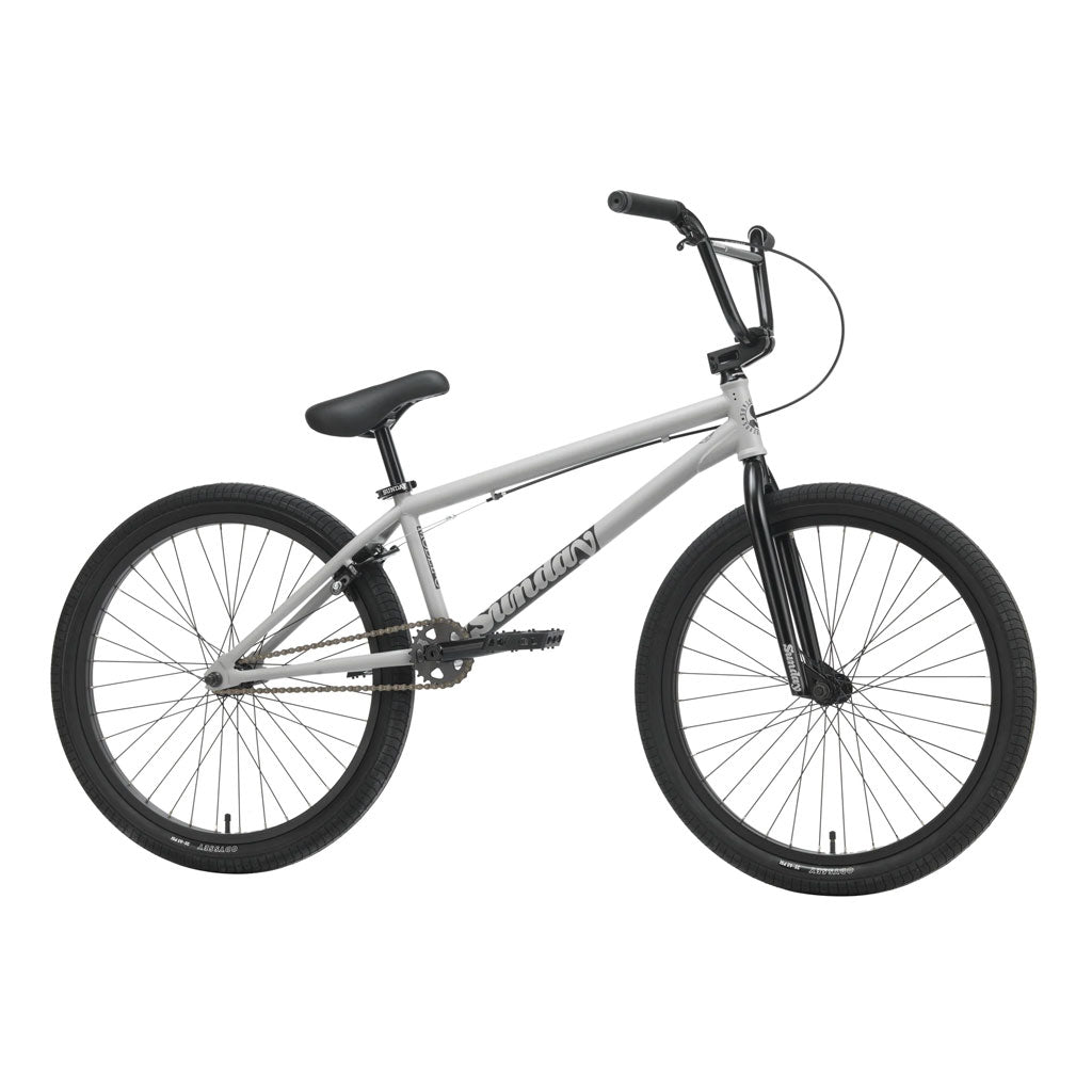 The Sunday Model C 24 Bike, featuring a gray 24” BMX design with black handlebars, seat, and tires, and incorporating Odyssey parts, is shown against a plain white background.