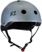 A S-One Helmet Mini Lifer Silver Gloss Glitter with a black interior padding, featuring the logo "S1". It incorporates EPS Fusion Foam for multi-impact protection, multiple ventilation holes, and an adjustable chin strap with a red buckle.