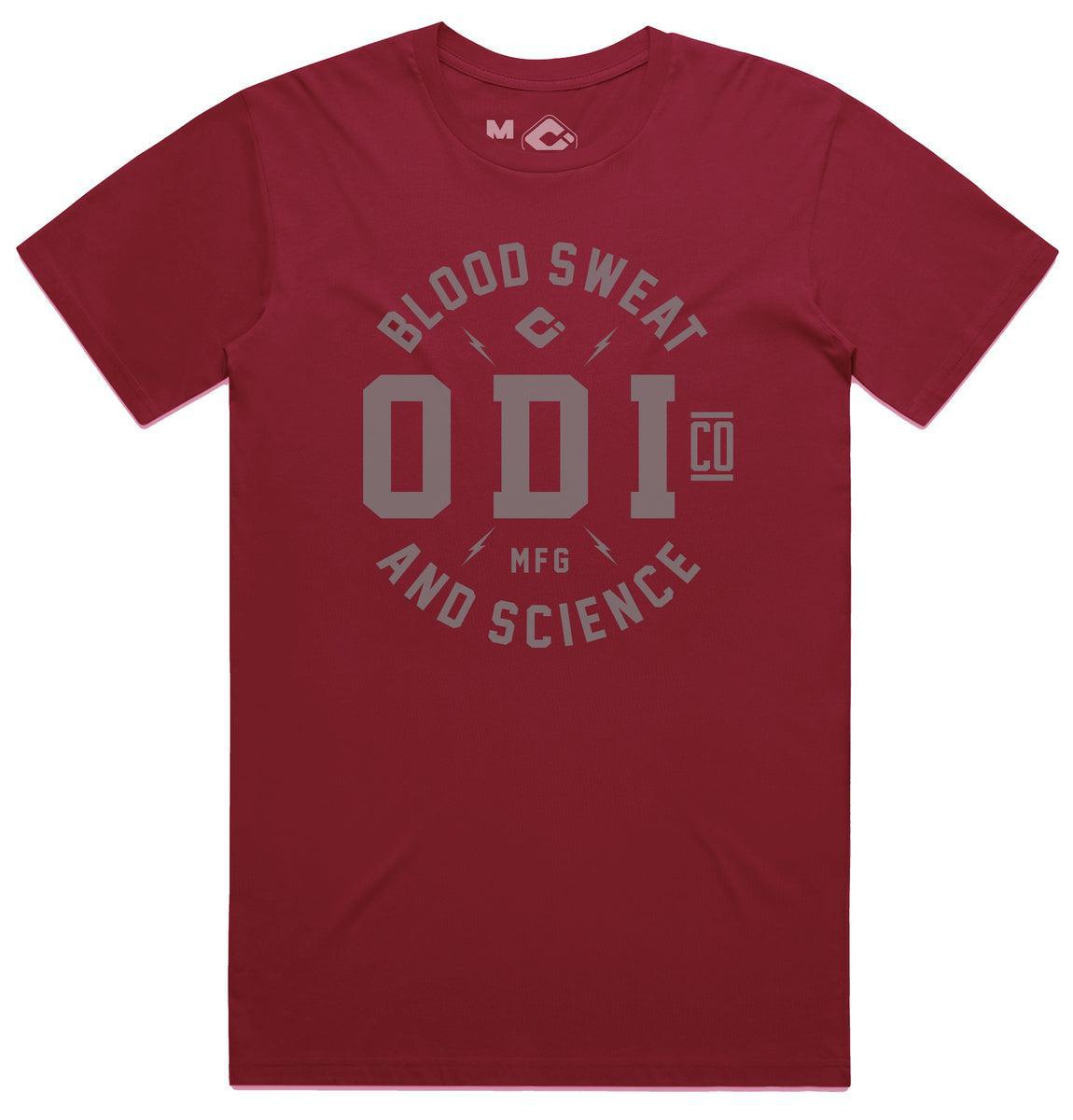 The ODI Token T-Shirt in red features "Blood Sweat and Science ODI Co MFG" in gray on the front, made from soft ring-spun cotton jersey for comfort on any adventure.