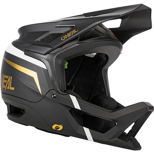 Introducing the Oneal Transition Helmet—a lightweight black and gold full-face Enduro mountain bike helmet that includes a visor, showcases the O'Neal logo prominently, and features a magnetic buckle for enhanced convenience.