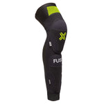 Fuse Omega 100 Knee Shin Combo Pads feature a black and yellow-green X design with the "FUSE" brand name, visible padding on knees and shins, and durable Kevlar sections for enhanced protection.