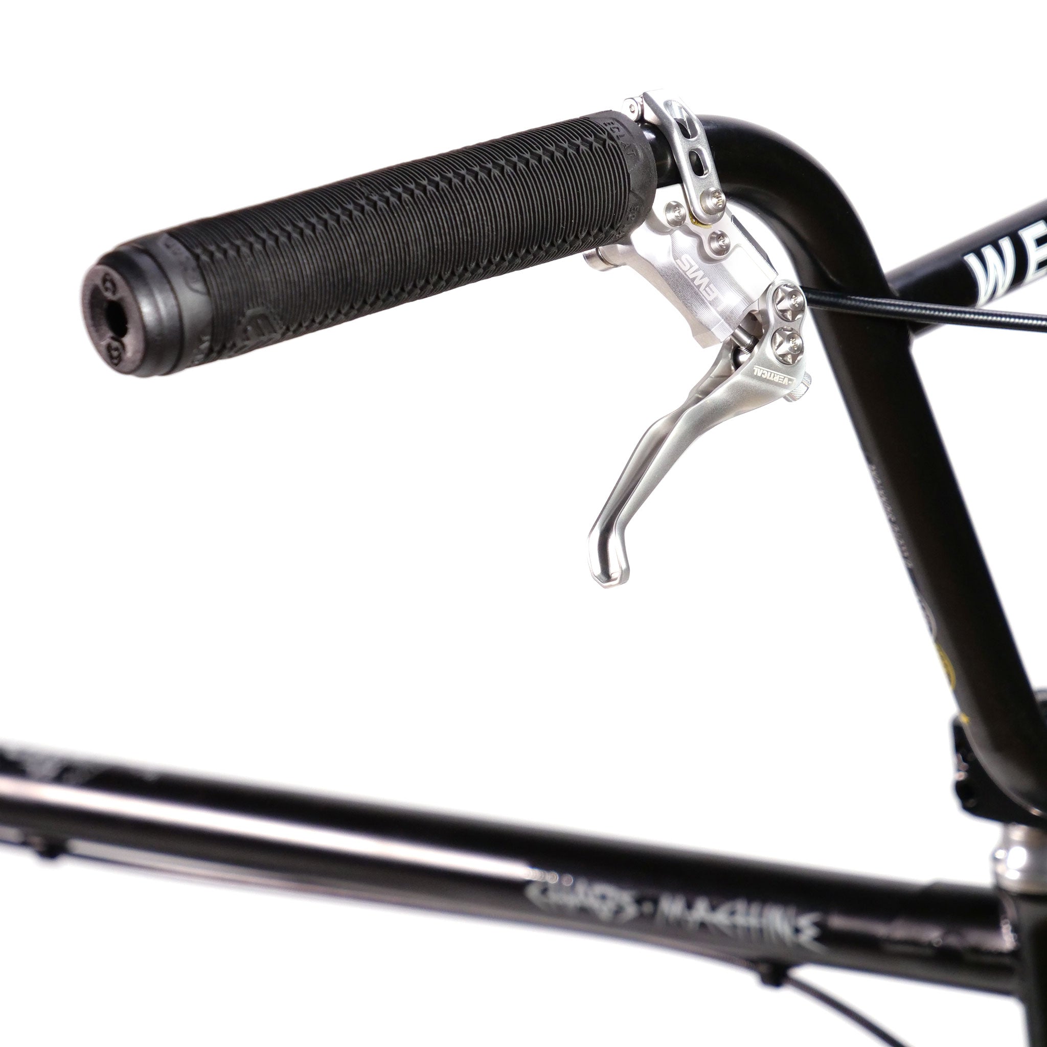 Close-up of a bicycle handlebar with a black rubber grip and a silver brake lever, showcasing the precision design of the Wethepeople Chaos Machine 22 Inch Custom Bike. The background is white, highlighting part of the 22 Inch Tyson Jones-Peni Frame in vivid detail.