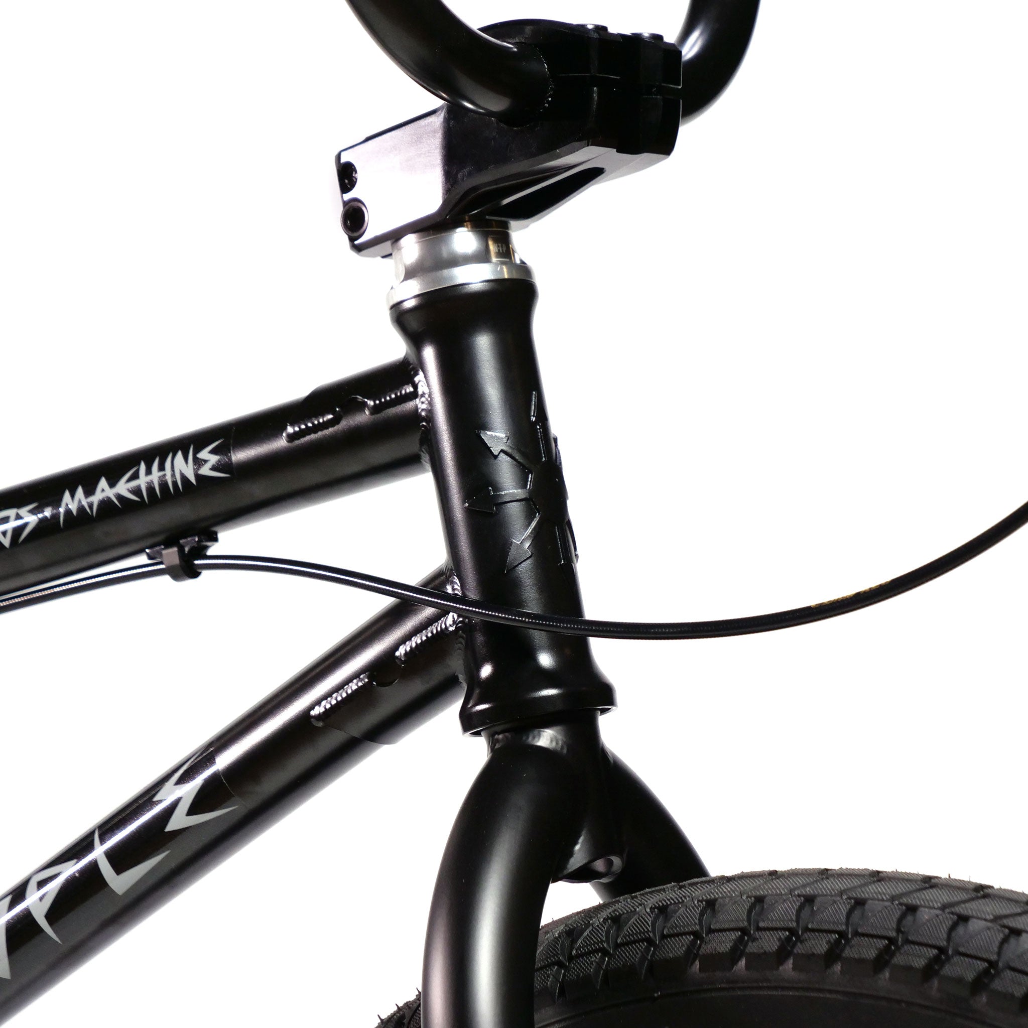 Close-up of a black Wethepeople Chaos Machine 22 Inch Custom Bike's frame's front section with handlebars and a visible front tire. The words "machine" and "Temple" are partially visible on the frame, highlighting the dynamic design of this BMX 22 Inch marvel.