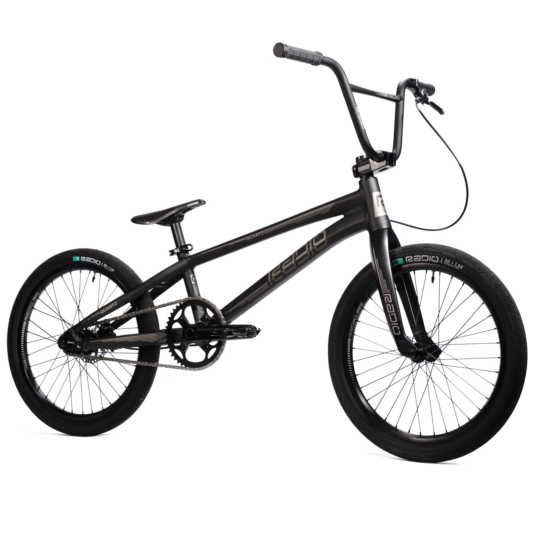 The Radio Quartz Pro XL Bike 2025 is a black BMX bike equipped with a lightweight hydro-formed frame, a narrow seat, large pedals, and a simple design. It features thick tires, hydraulic disc brakes, and a single brake lever.