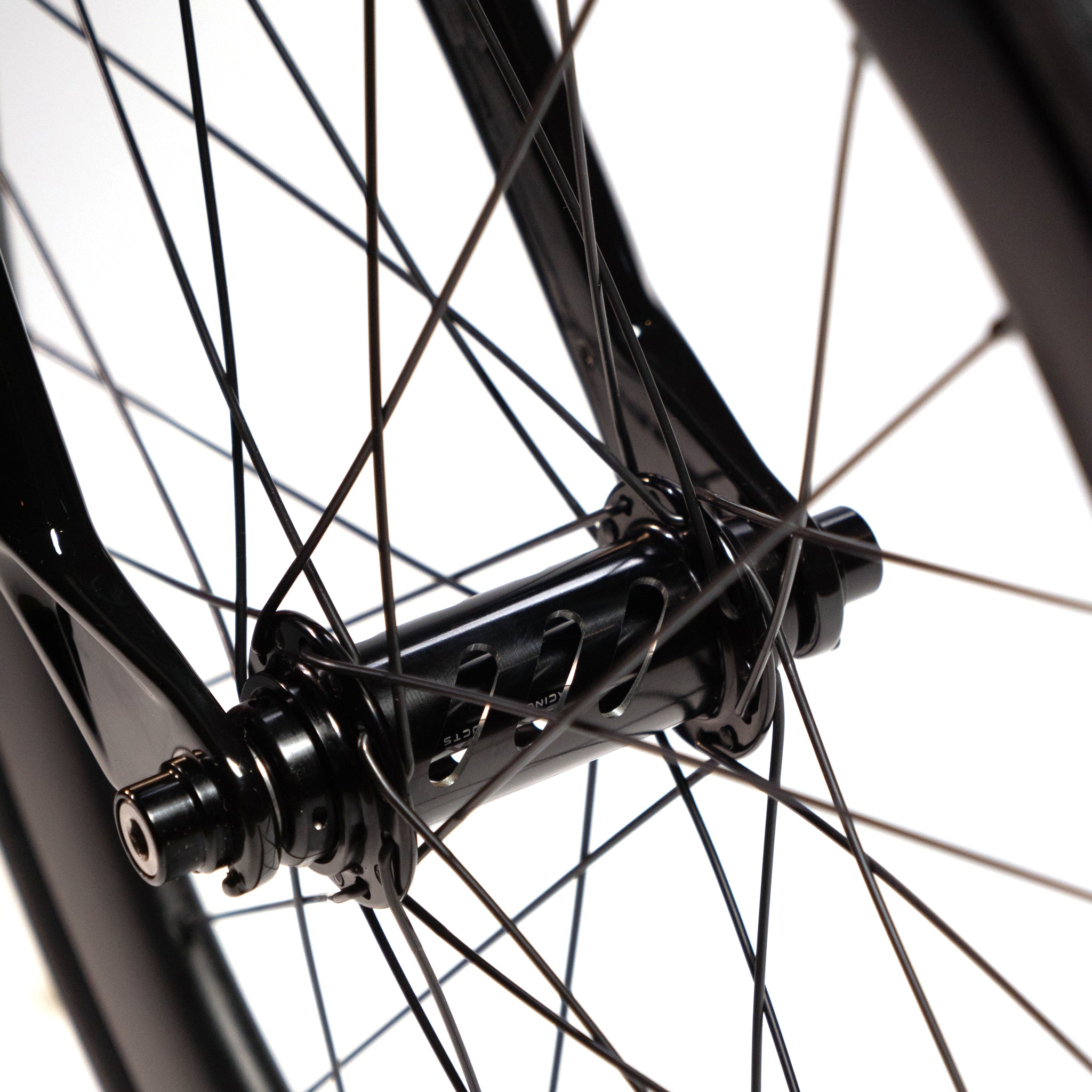 Close-up view of a Meybo Holeshot Junior Custom Bike wheel hub with multiple black spokes extending from it. The background is plain white, and the focus is on the detailed structure of the hub and spokes, complemented by BOX carbon forks.