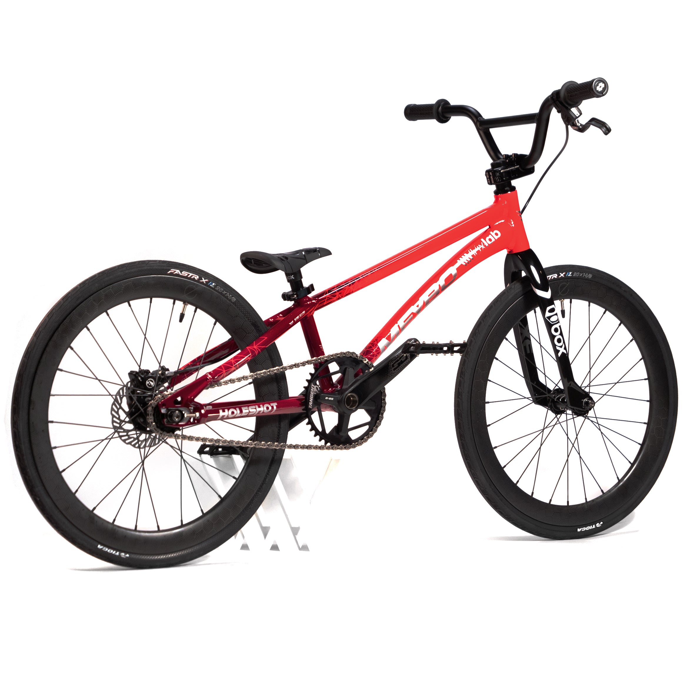 The Meybo Holeshot Junior Custom Bike, showcasing a striking red and black color scheme, boasts large black tires, front and rear brakes, BOX carbon forks, and a flat seat, all displayed against a white background.