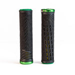 Two ODI CF Lock On Grips V2.1 Izaac Kennedy Signature BMX racing grips are showcased upright against a white background. One grip features a hexagonal pattern with green ends, while the other boasts a slotted design with green accents, echoing the style of an Olympic gold medalist's winning gear.