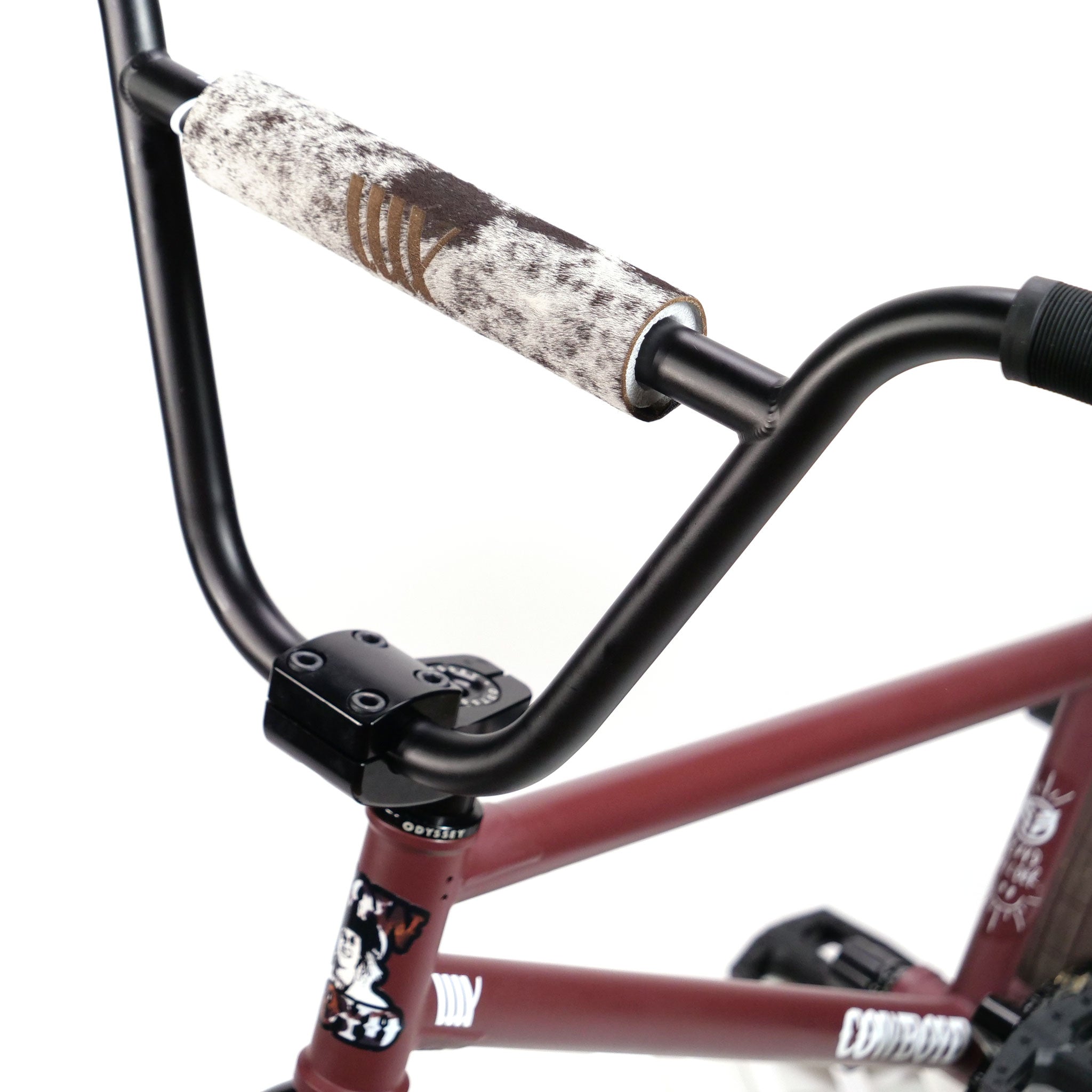 Close-up of the handlebar on the Federal CowBoyd Custom 20 Inch Bike, showcasing a worn, cushioned crossbar pad and a maroon frame adorned with Federal graphics and text.