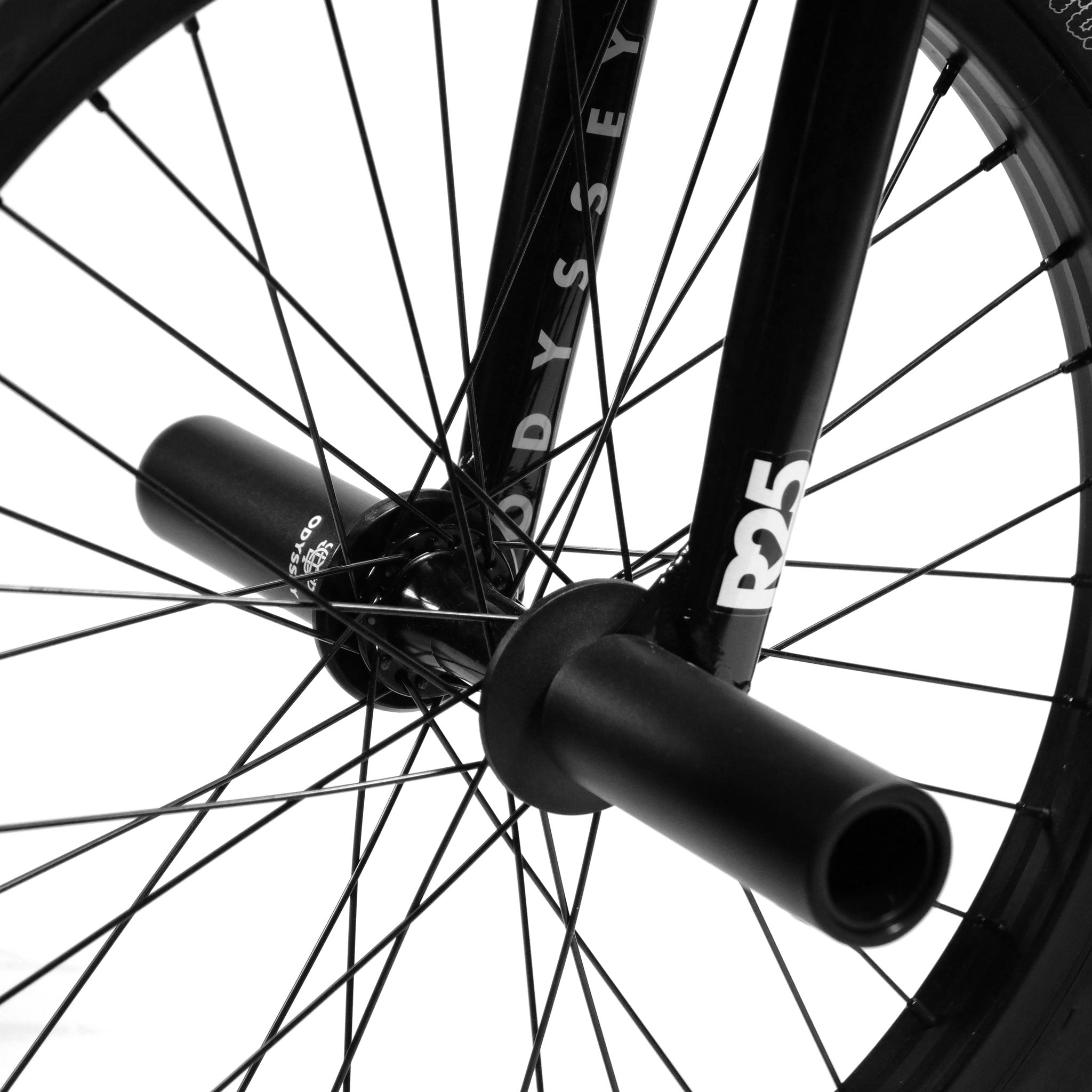 Close-up of the Federal CowBoyd Custom 20 Inch Bike's front wheel with black spokes, a peg, and the label "R25" on the fork, featuring an Odyssey design.