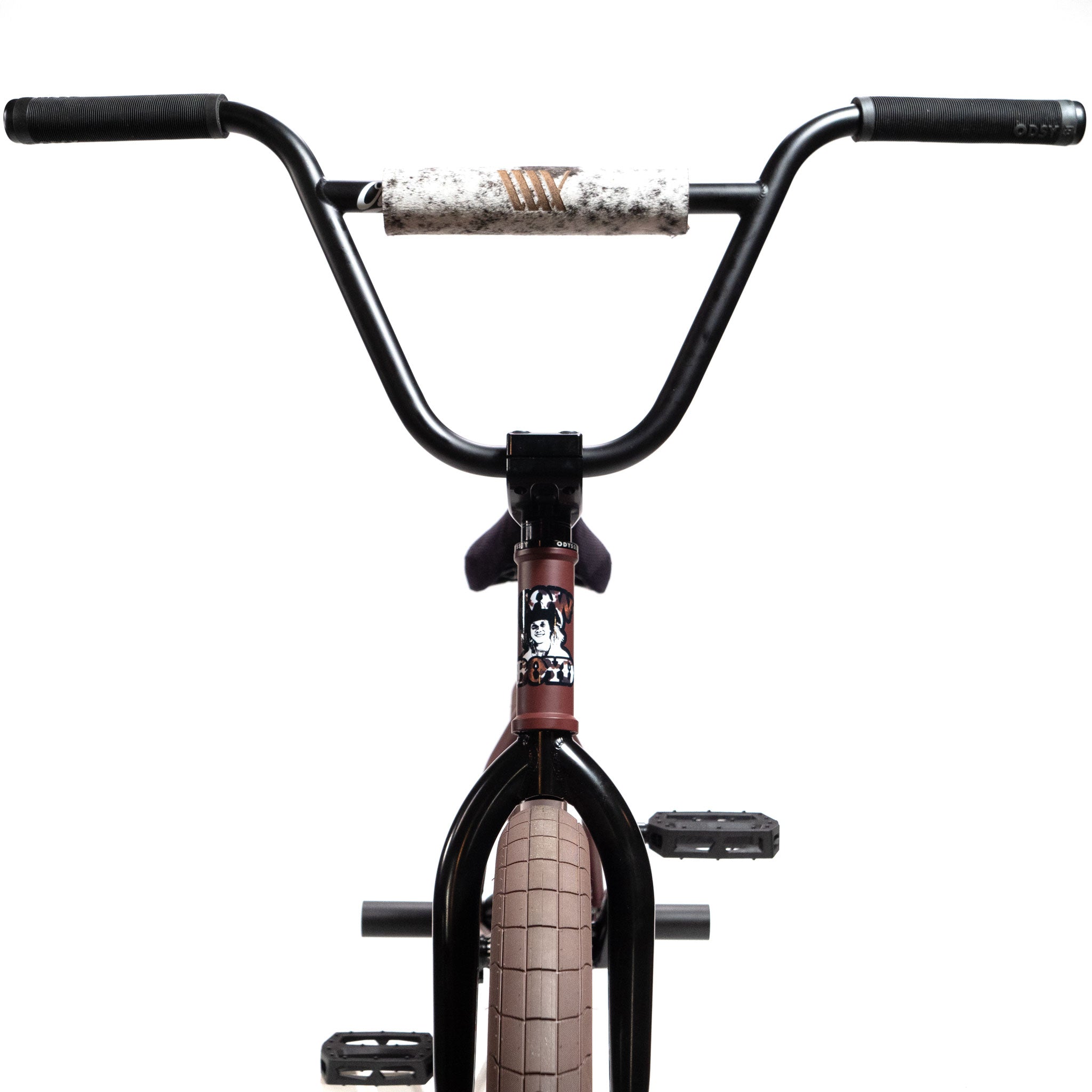 Front view of the Federal CowBoyd Custom 20 Inch Bike featuring black handlebars with a padded crossbar, an Odyssey sticker on the frame, and beige tires set against a white background.