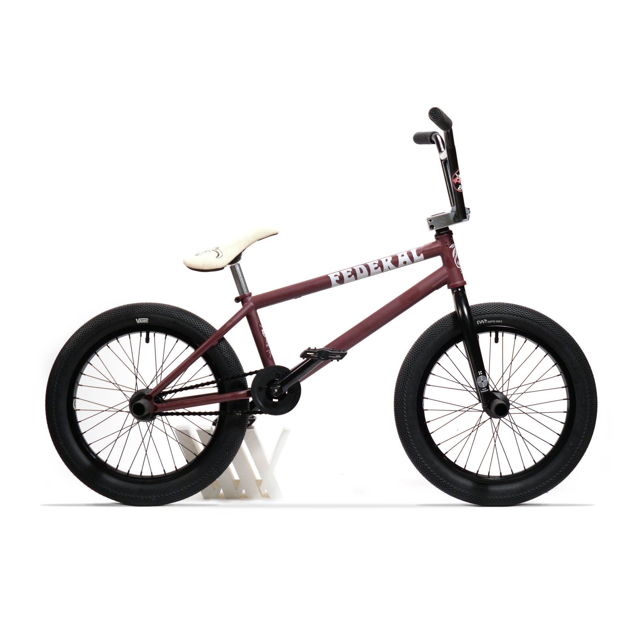 A maroon Federal YUNGBOYD Custom 18 Inch BMX bike, featuring a white seat, black wheels, and the "Federal" logo on its frame, customized with aftermarket parts for freestyling, stands proudly on a white bike stand.