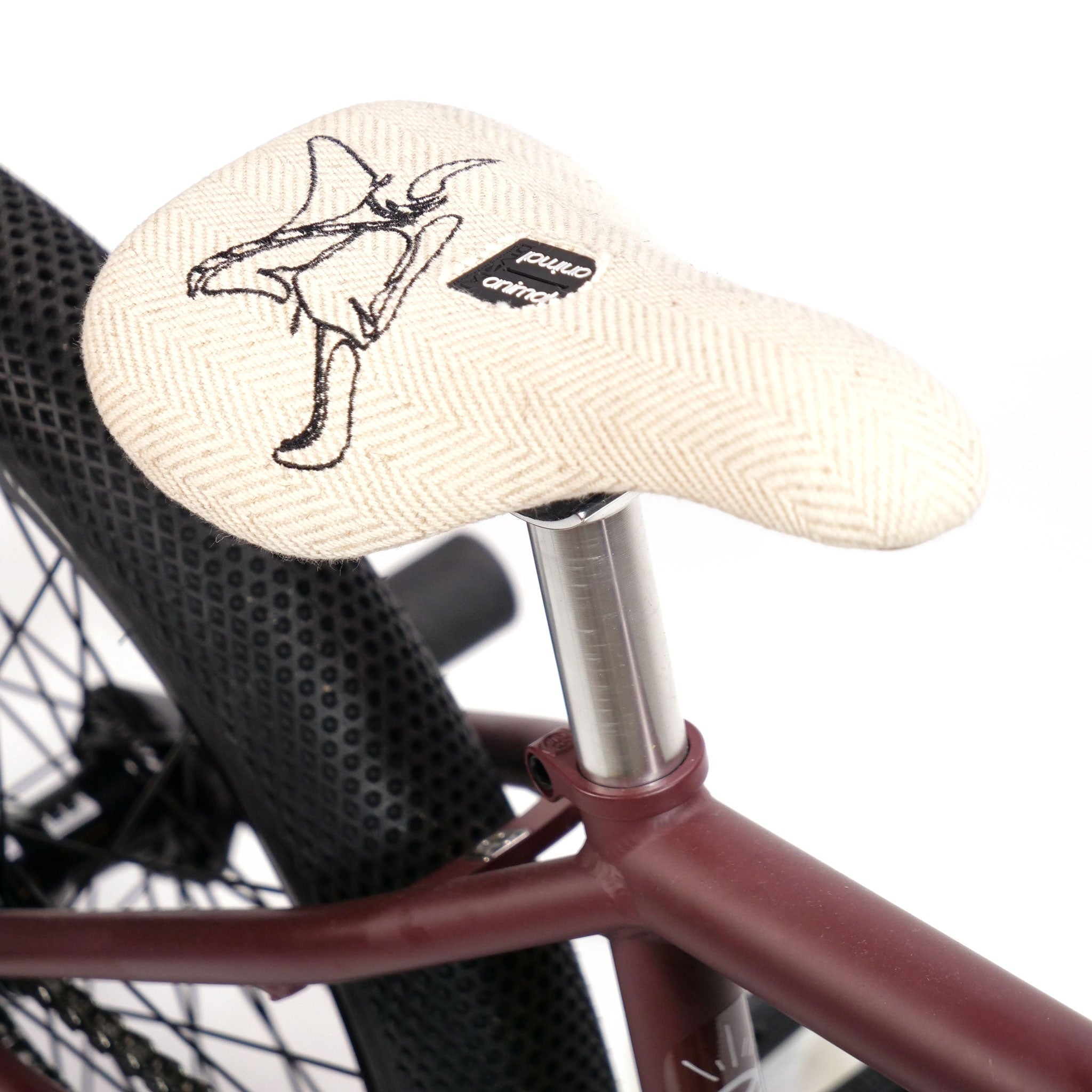 Close-up of the Federal YUNGBOYD Custom 18 Inch Bike, featuring a uniquely designed light beige seat with a large animal illustration and text labels. The bike has a dark red frame and black wheels, enhanced by stylish aftermarket parts.