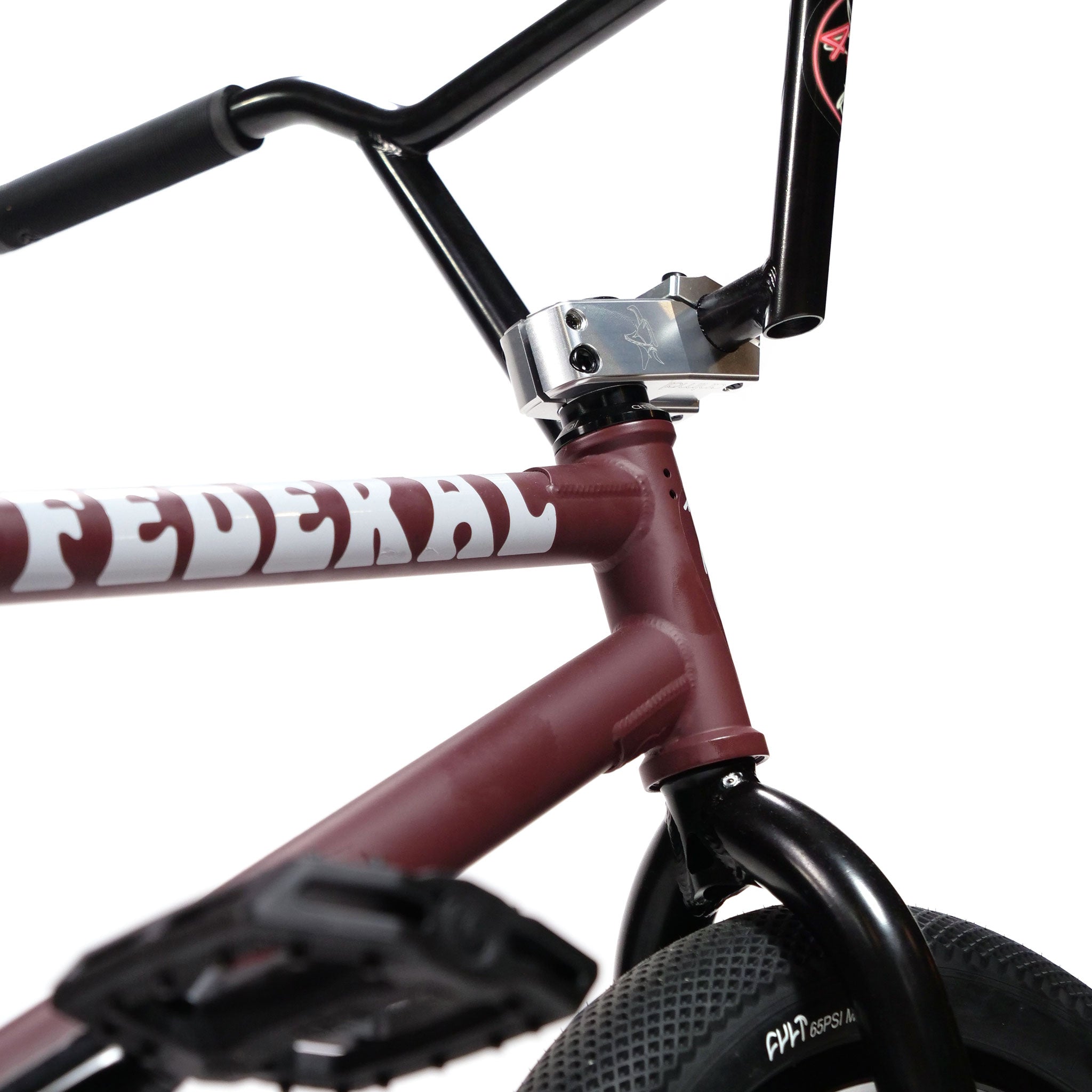 A close-up of the Federal YUNGBOYD Custom 18 Inch Bike frame in maroon showcases bold white lettering, giving a detailed view of the freestyle custom handlebars, top tube, and front wheel area, complete with sleek aftermarket parts for enhanced performance.