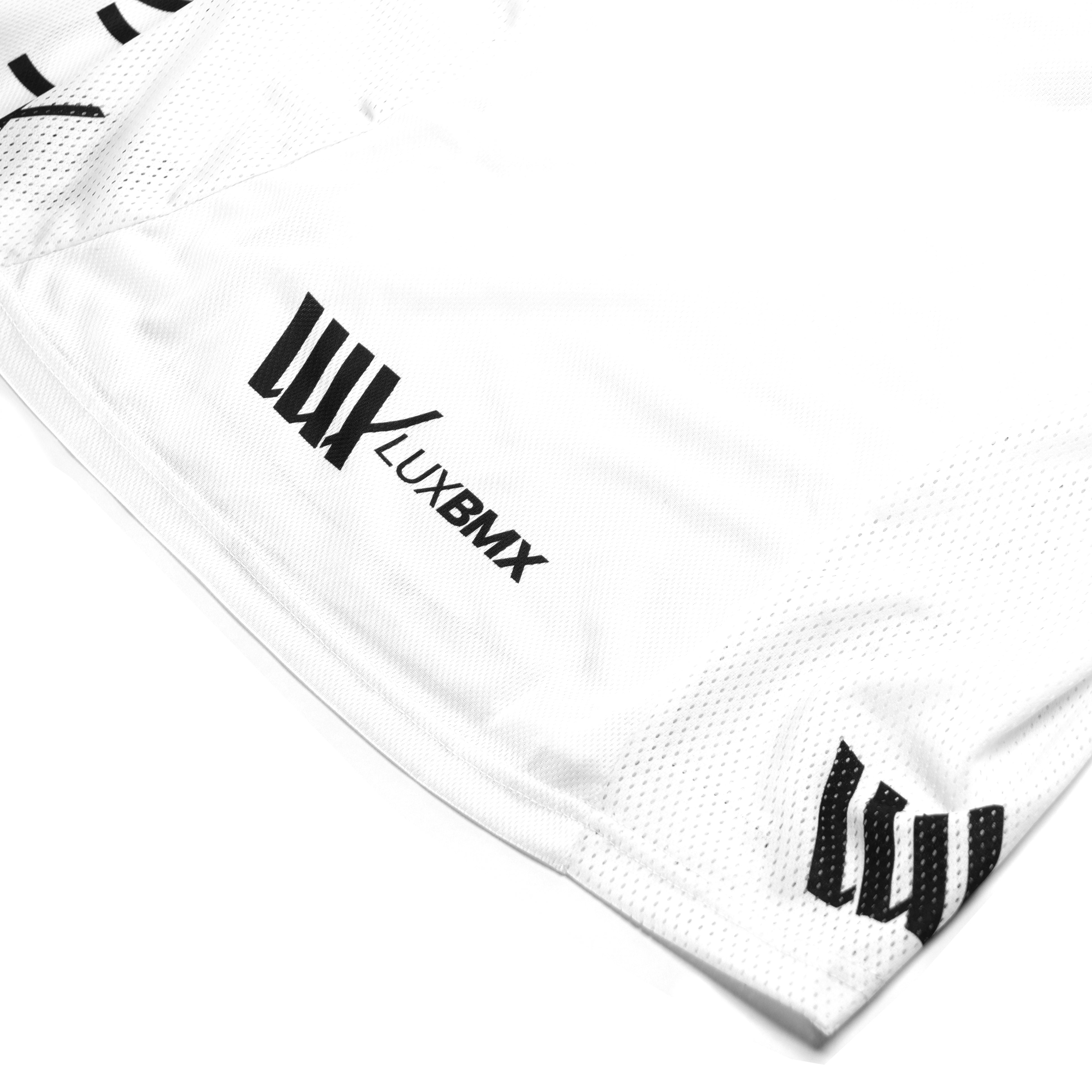 A section of the LUXBMX Race Jersey White V2 features black logos and text that reads "LUXBMX.