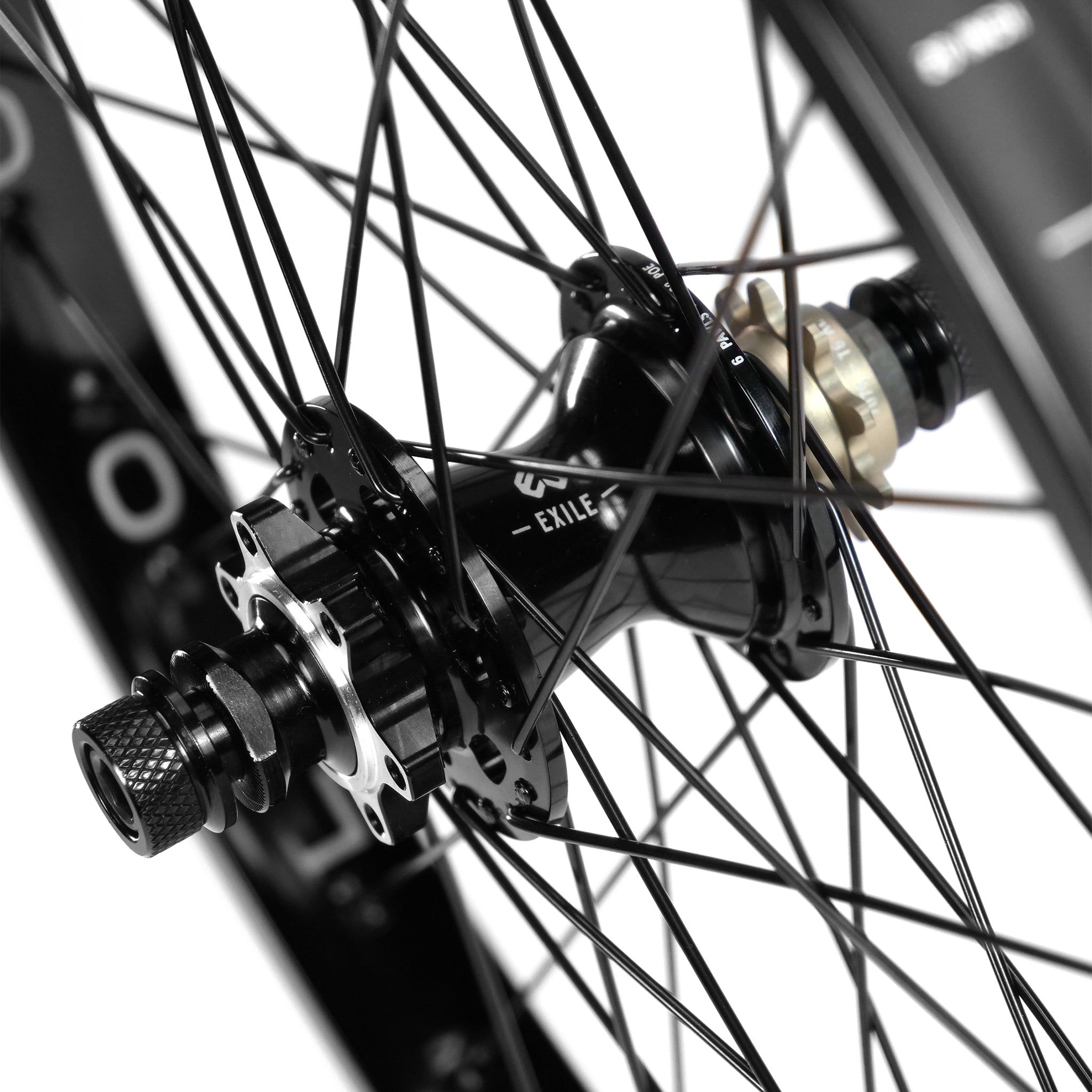 A close-up of the Eclat Locater / Exile Rear Wheel hub showcases black spokes, a threaded axle, and a disc brake rotor mount.