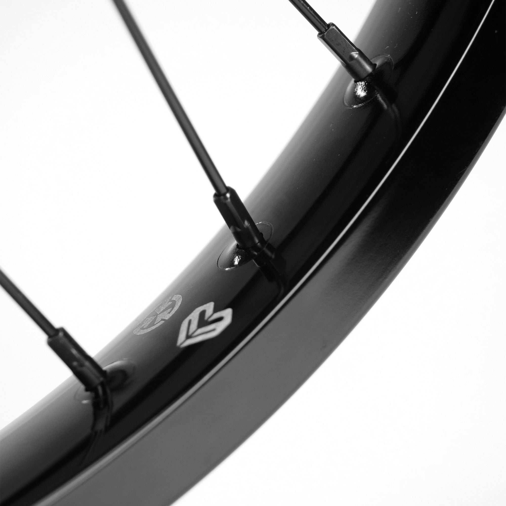 Close-up of an Eclat Locater / Exile Rear Wheel, showcasing its black rim with spokes perfectly joined to the hub, and finished with a sleek disc brake rotor mount.