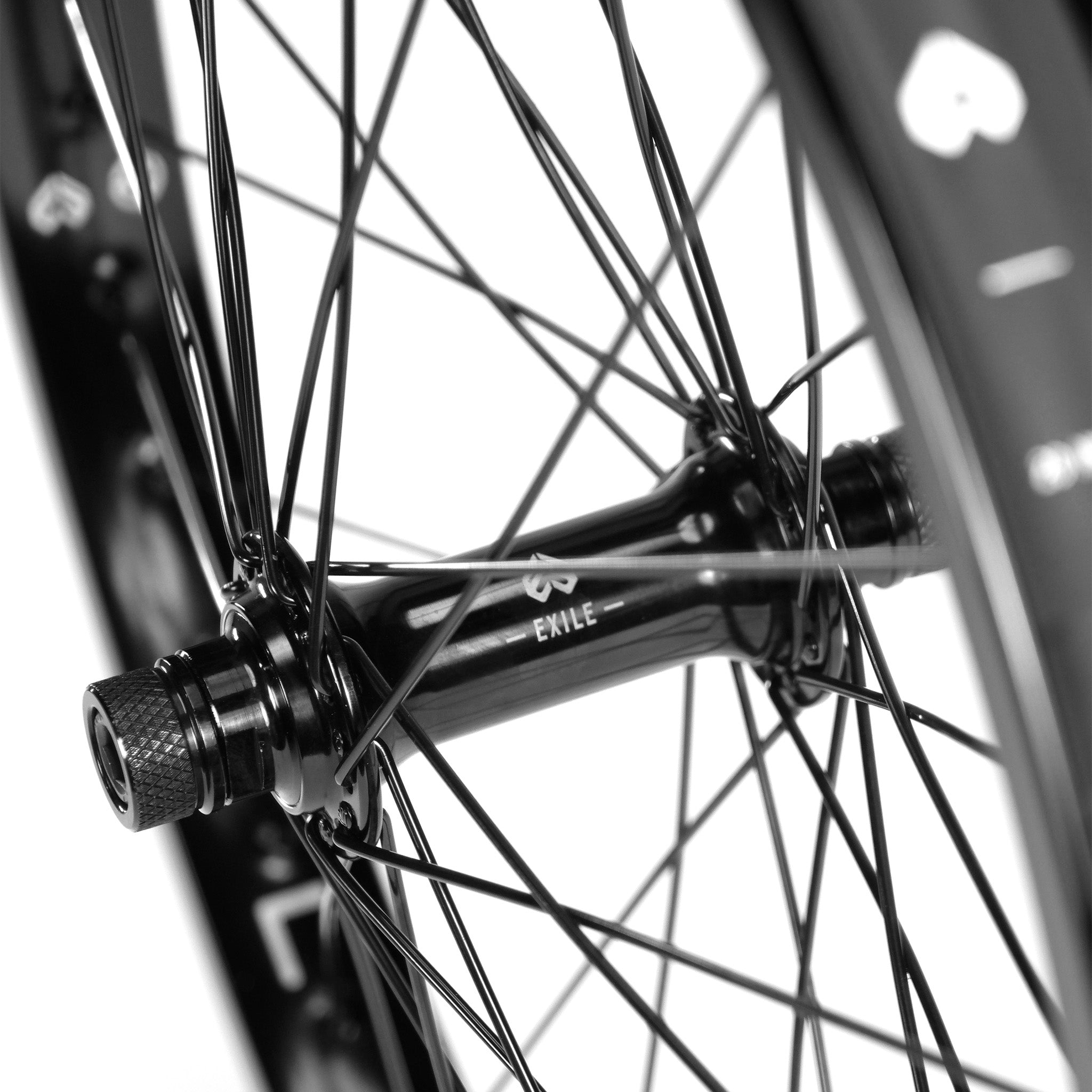 Close-up of an Eclat Locater / Exile Front Wheel hub with steel spokes, featuring a centered "EXILE" logo.