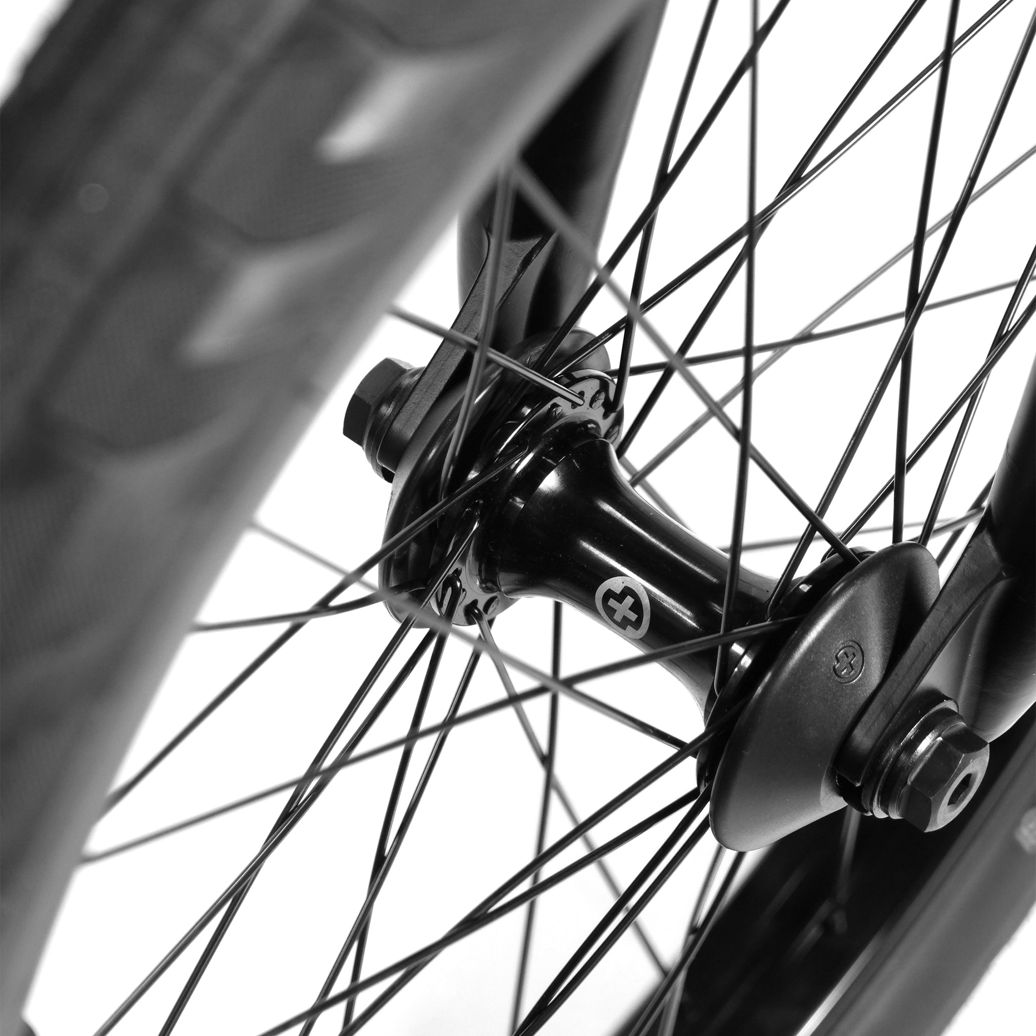 Close-up of the BSD Long Shot Custom BMX Bike's wheel hub featuring black spokes and a black tire.