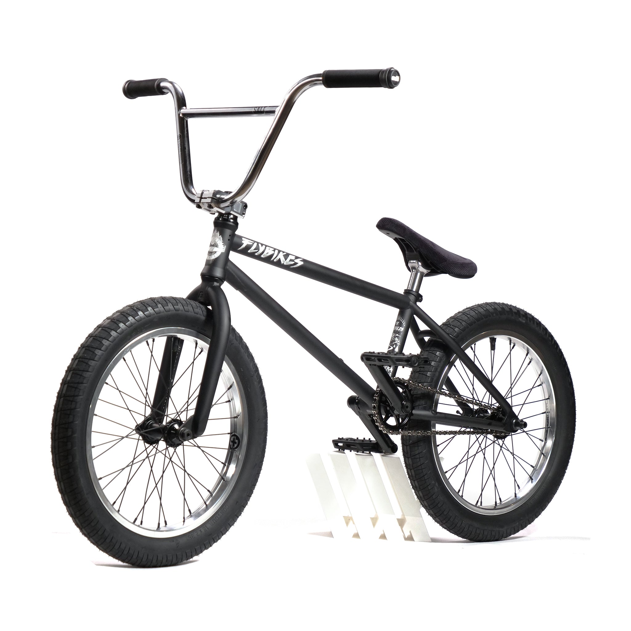 The Fly Bikes Pajarito Custom 18 Inch BMX Bike features large tires, a padded seat, and a straight handlebar, displayed against a white background.