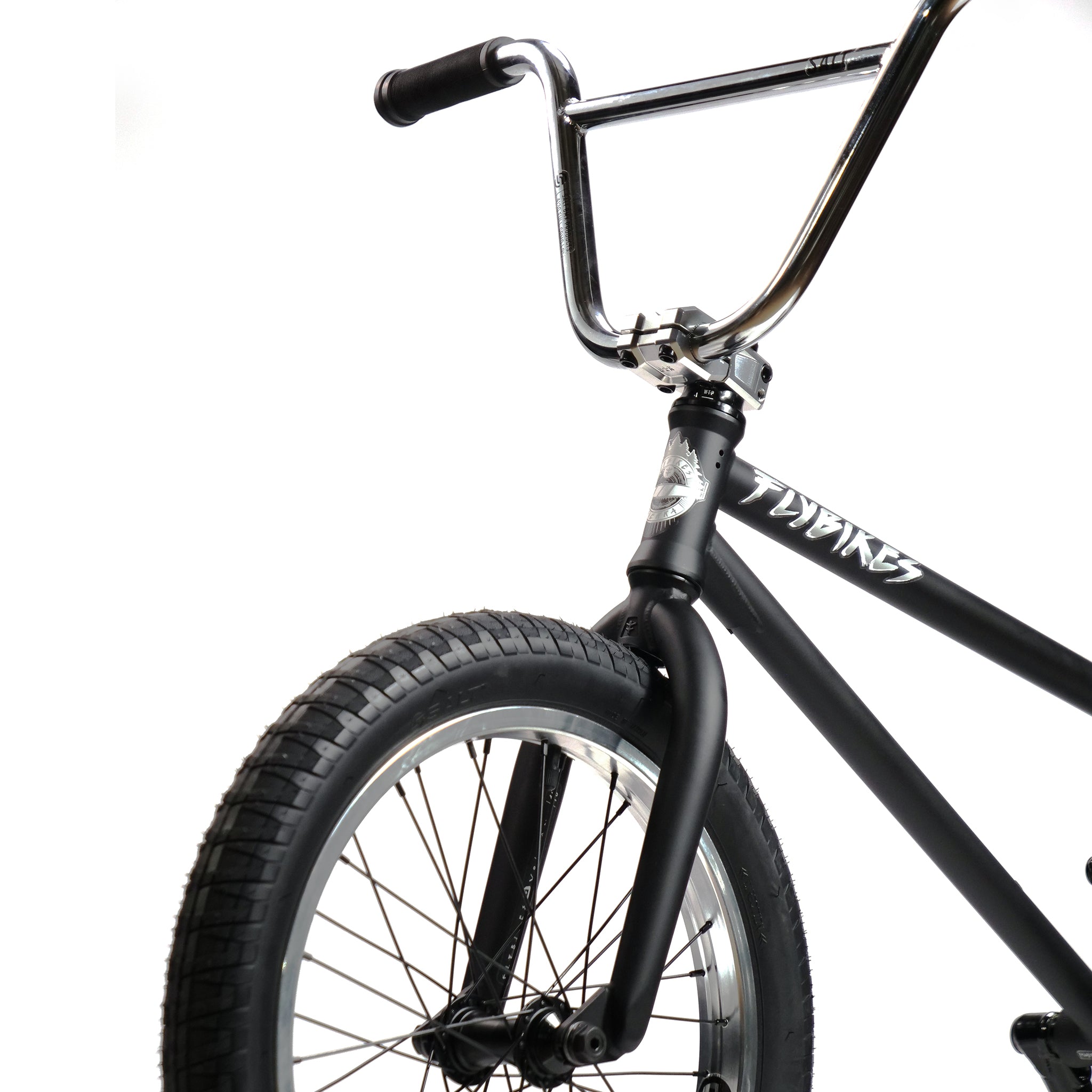 Close-up of the Fly Bikes Pajarito Custom 18 Inch BMX Bike showing the handlebars, matte black frame with brand name, and front tire.