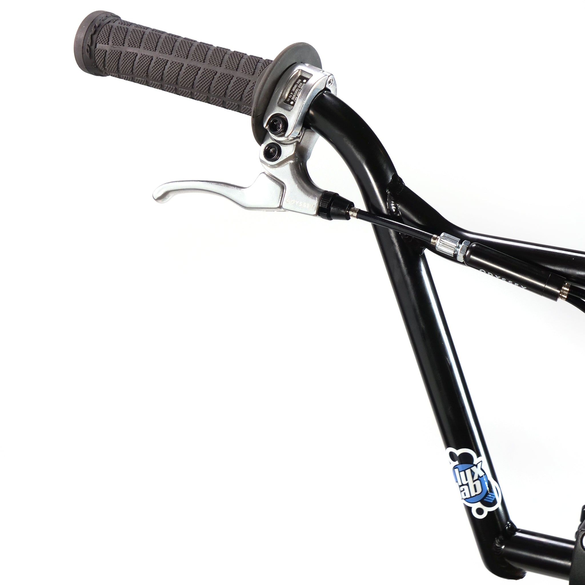 Close-up of a black bicycle handlebar with a grey rubber grip and silver brake lever. The frame features the Hoffman TAJ Trend Adjacent Joy 20 Inch Custom Bike logo, echoing BMX freestyle legends like Hoffman bikes, in blue and white elements.