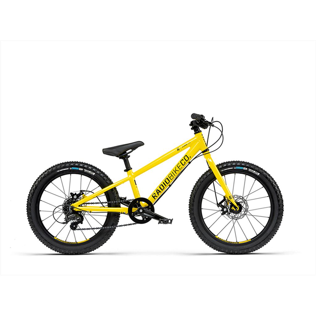 The Radio 20 Inch Zuma Bike, a children's MTB featuring a lightweight yellow alloy frame, black seat, and black tires, is shown from the side on a white background.