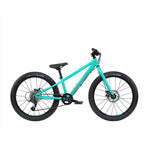 The Radio 24 Inch Zuma Bike, featuring a lightweight alloy frame, comes in a vibrant turquoise color with thick tires and flat handlebars. It boasts a black saddle and pedals, equipped with gears and a chain drive system—perfect for young adventurers.